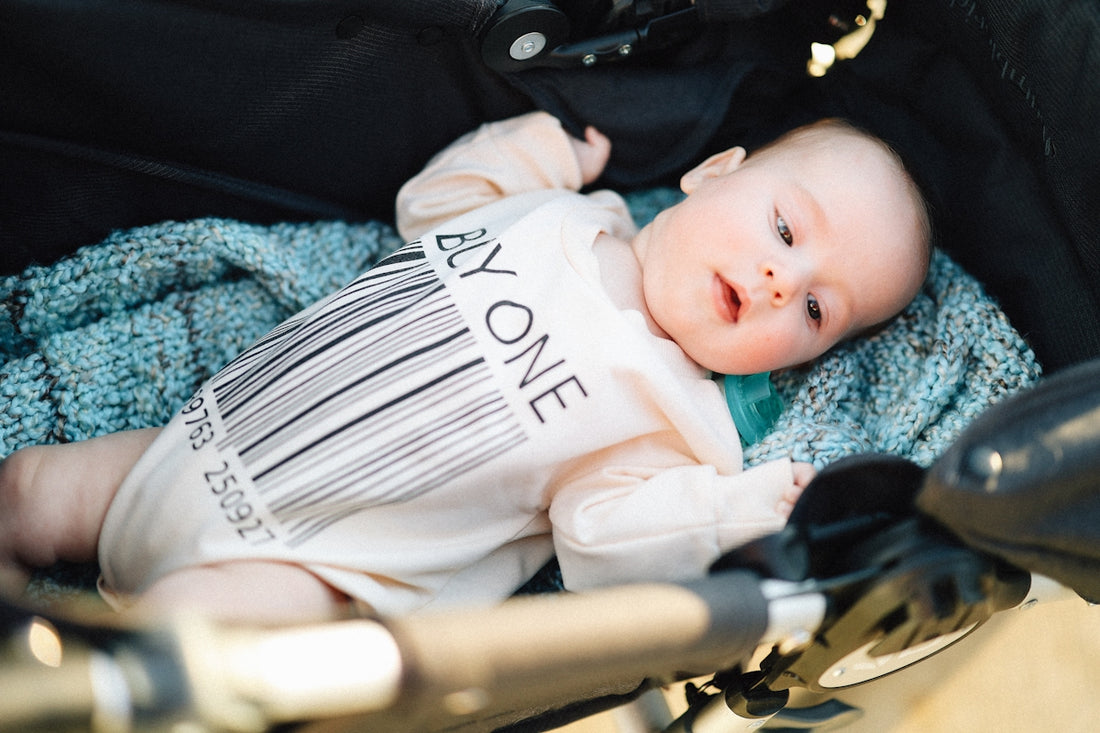 A baby is relaxing in a stroller.